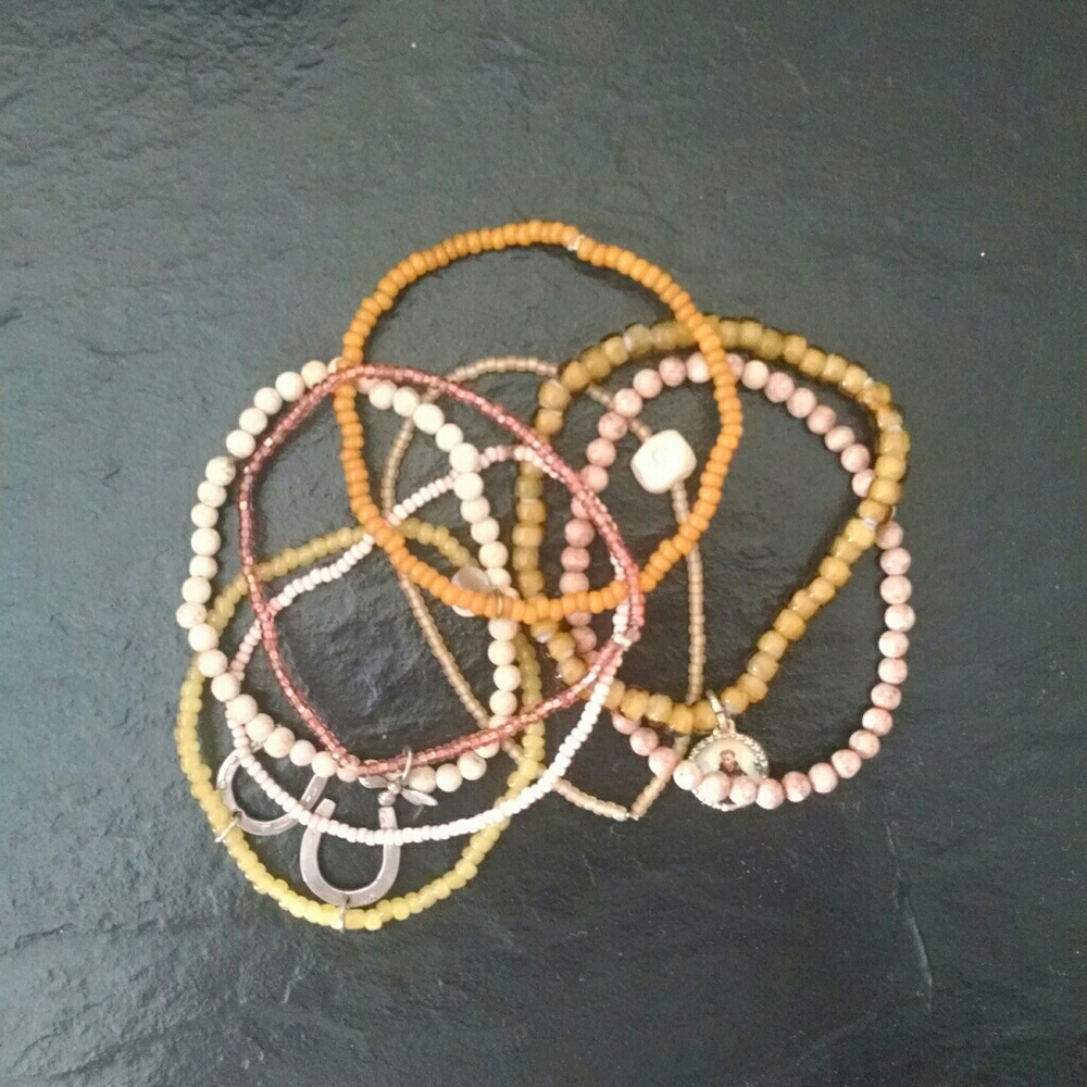 Bundle of beautiful beaded bracelets with charms